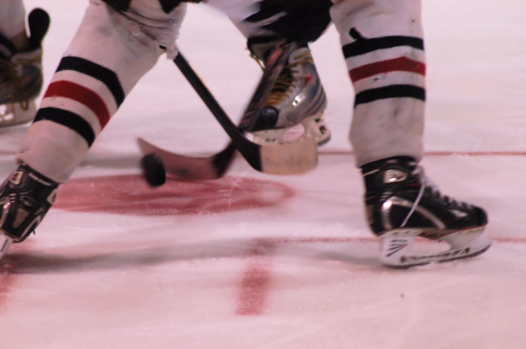 hockey skates, sticks and puck